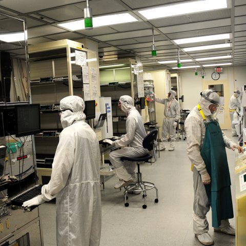 Researchers work in a nanofabrication clean room.